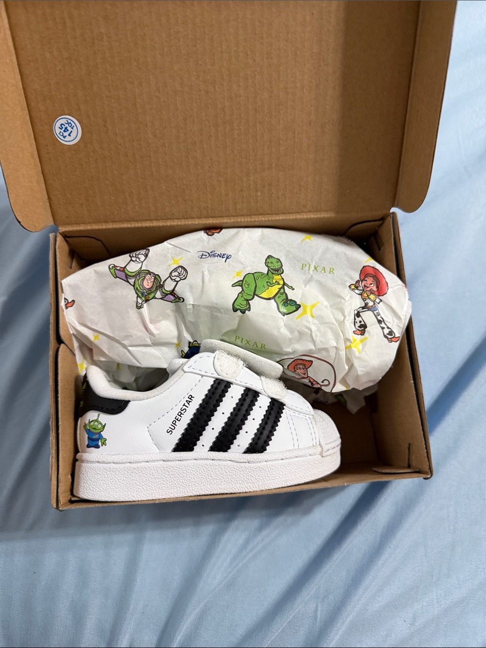 adidas White and Black Kids Superstar Sneakers with Toy Story Accents